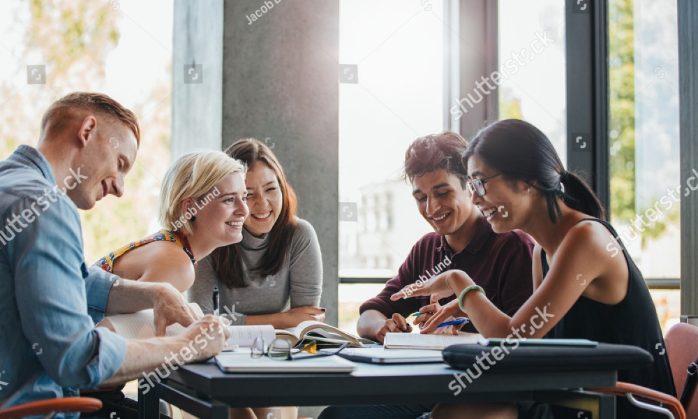 stock-photo-happy-young-university-students-studying-with-books-in-library-group-of-multiracial-people-in-522554425